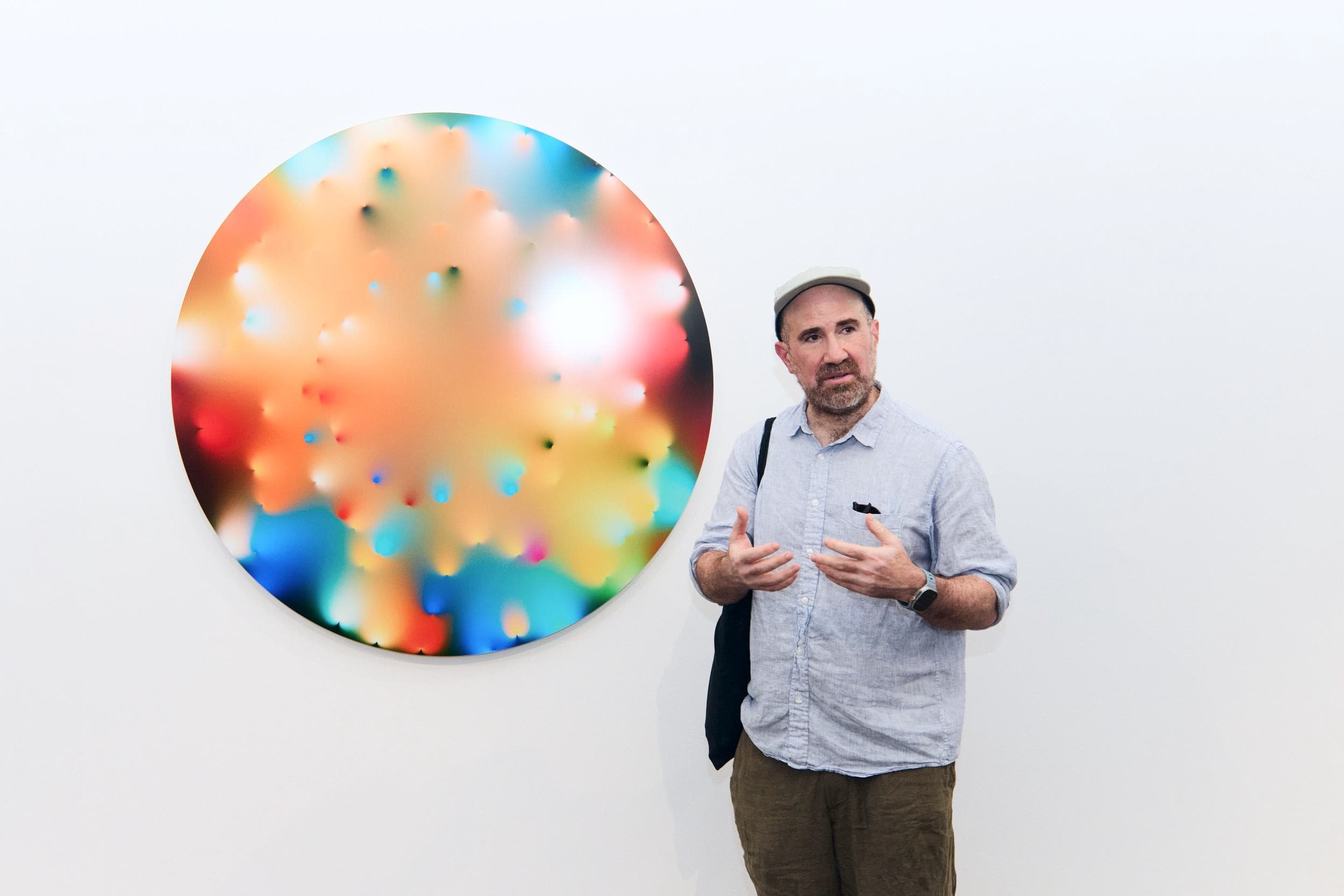 Zach Lieberman beside a dispersion disk work.